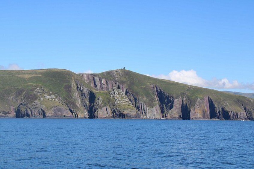 A coastal landscape with cliffs and a clear blue sky. 4