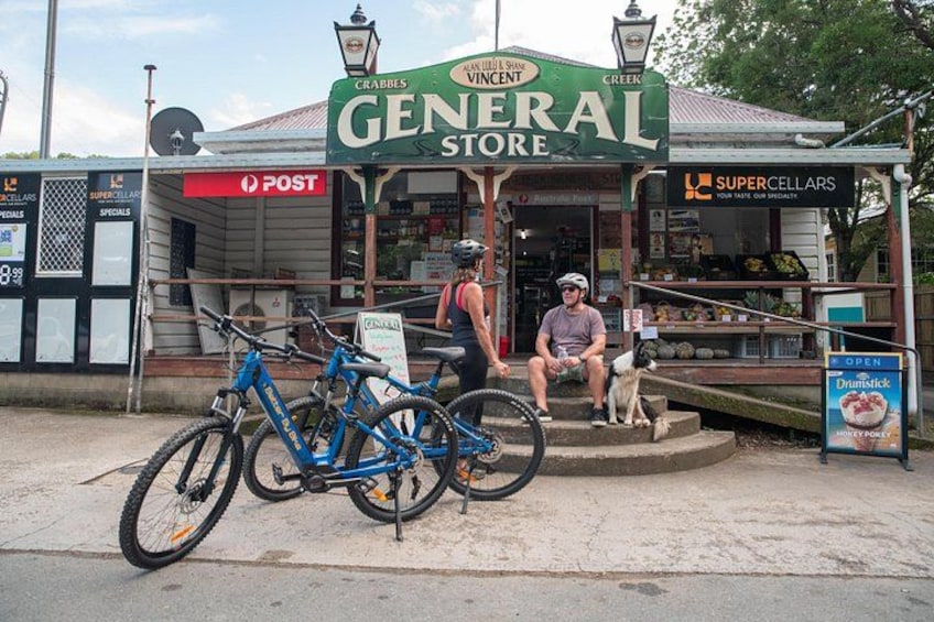 A bicycle parked in front of a store named 'General Store.' 4