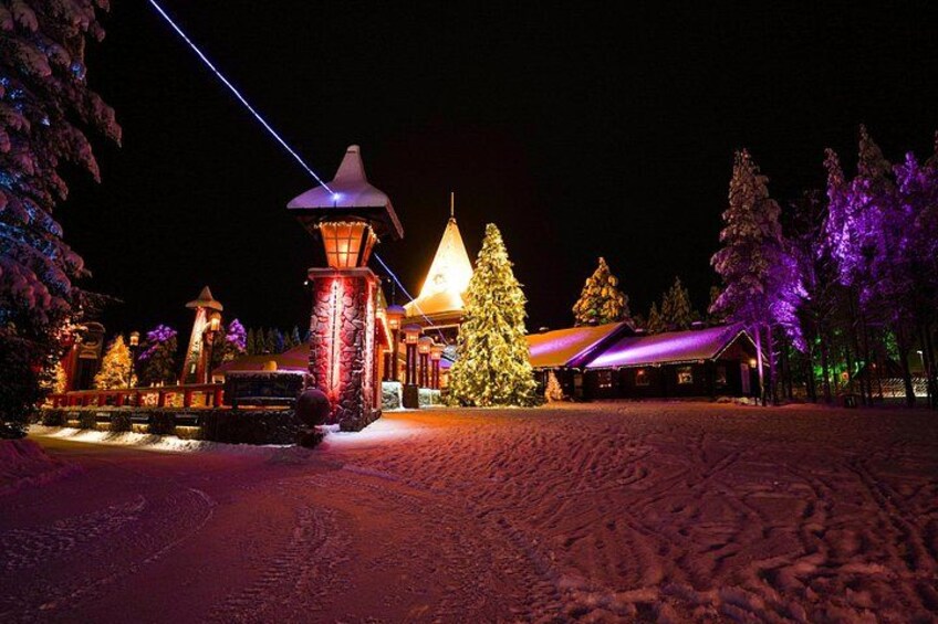A snow-covered landscape with a lit-up cabin, a snow-covered tree, and a stone lantern. 3