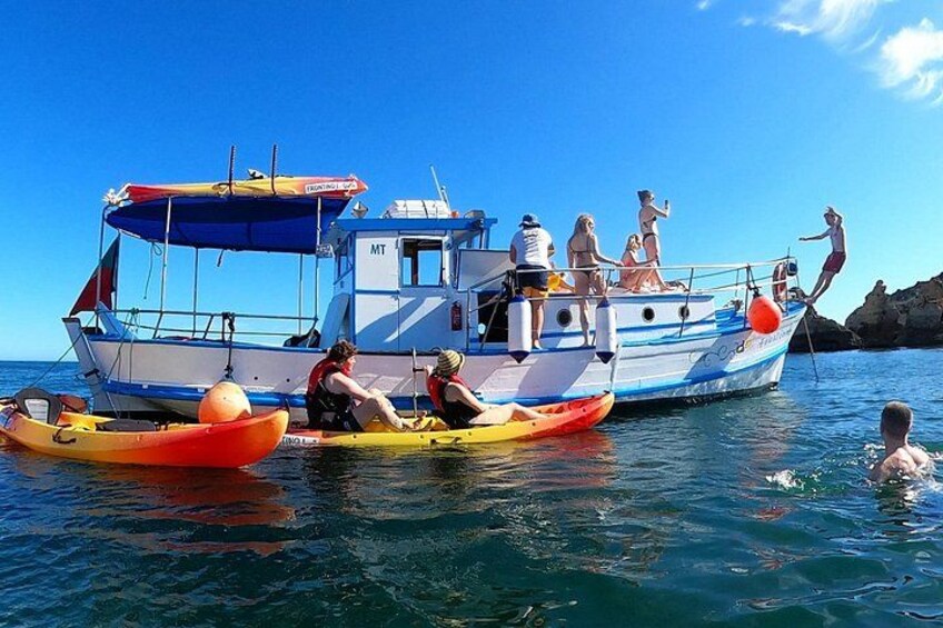 Experience the charm of a traditional Portuguese boat, kayaking, and swimming in crystal-clear waters. 4