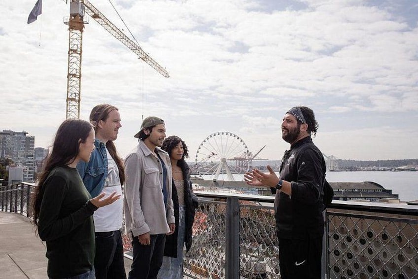 A group of people standing on a bridge with a Ferris wheel in the background. 3