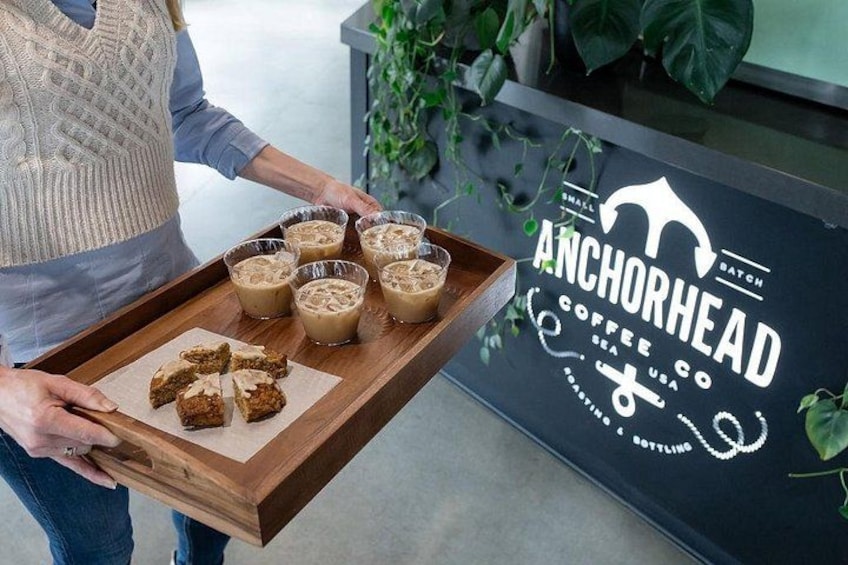 A person holding a tray with coffee and pastries at Anchorhead Coffee Co. 1