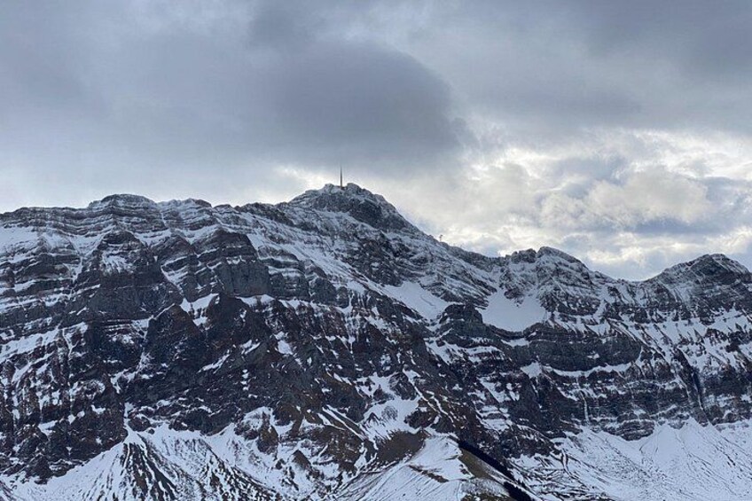 Snow-covered mountain peaks under a cloudy sky. 5