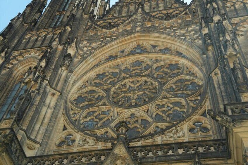A Gothic cathedral's intricate facade with detailed stonework and a large circular window. 2