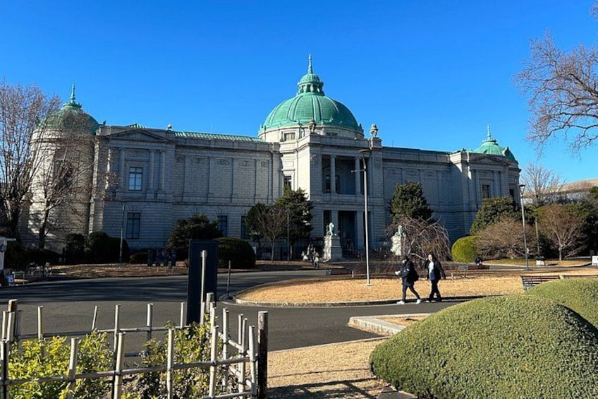 A large building with a green dome and classical architecture. 3