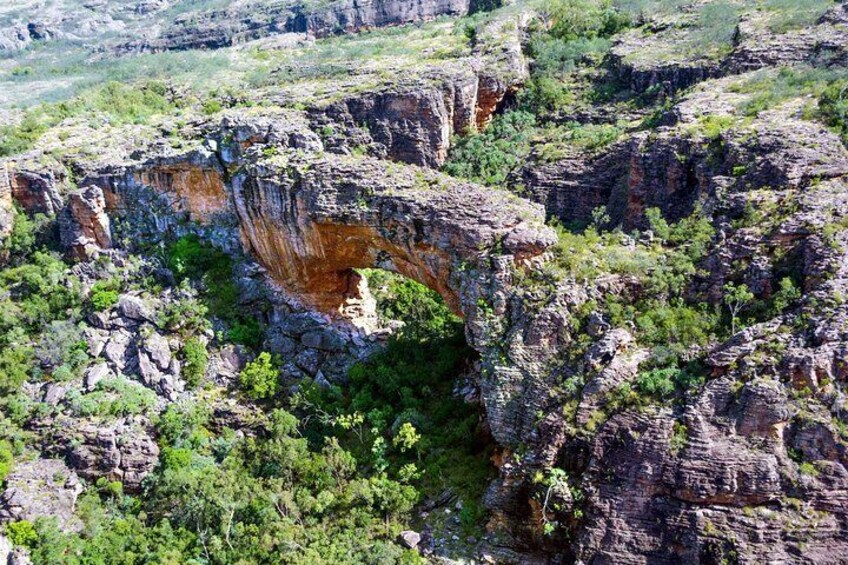 A large rock formation with a natural arch. 3