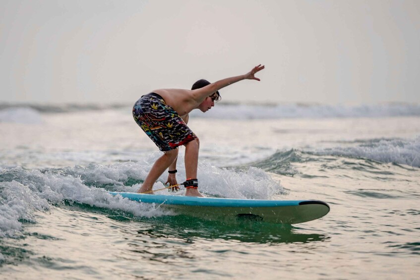 A person surfing on a wave. 5