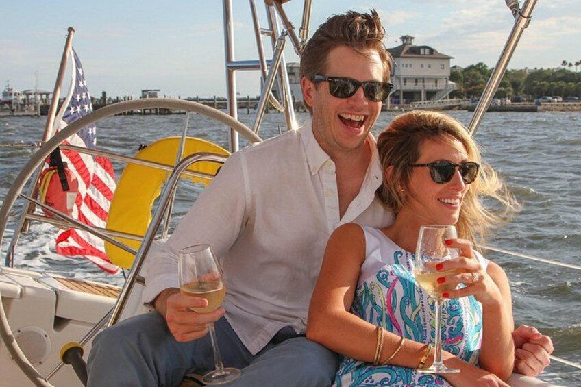 Two people on a boat with an American flag and a yellow life preserver. 4