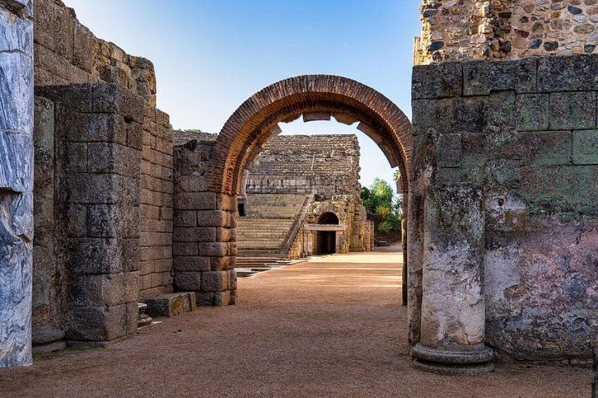 An ancient stone archway leading to a historical building. 4