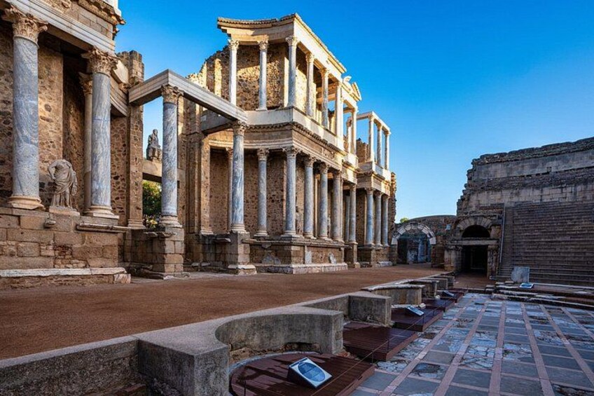 Ancient ruins with columns and a temple-like structure. 5