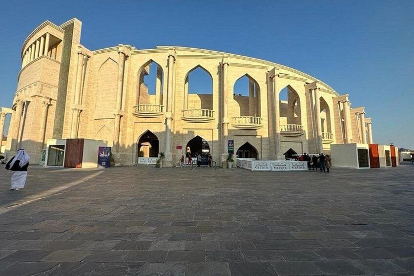 A large, historic building with arched windows and a central dome. 2
