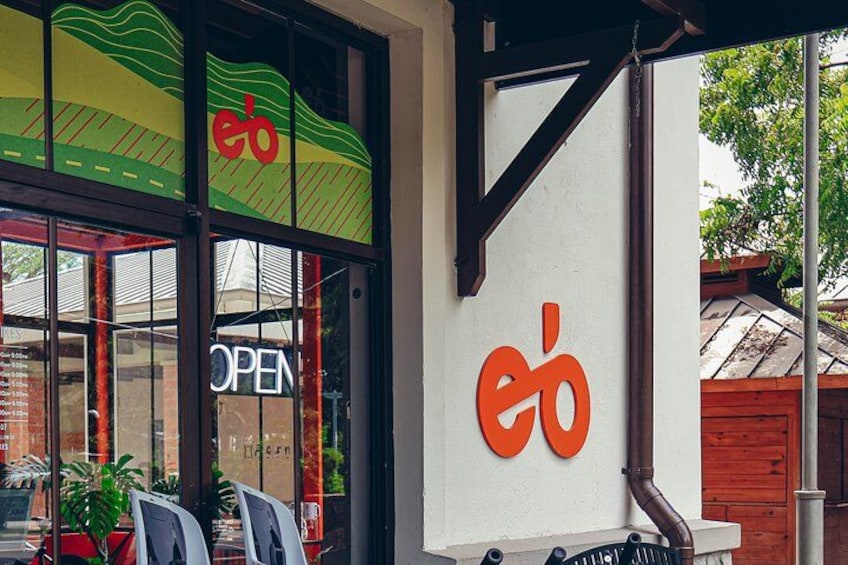 A storefront with a large glass window, a sign reading 'OPEN', and a logo with the letters 'eb' in orange. 3
