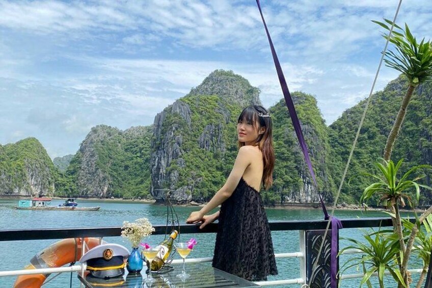 A person on a boat with a mountainous landscape in the background. 5