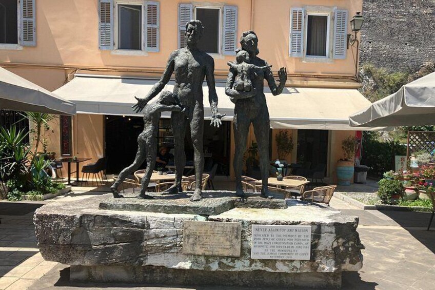 A statue of two figures, a man and a woman, with a plaque in front. 2