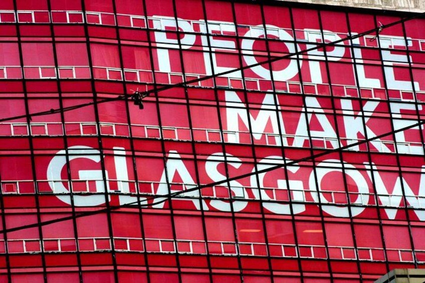 A red wall with the text 'PEOPLE MAKE GLASGOW' in white letters. 4