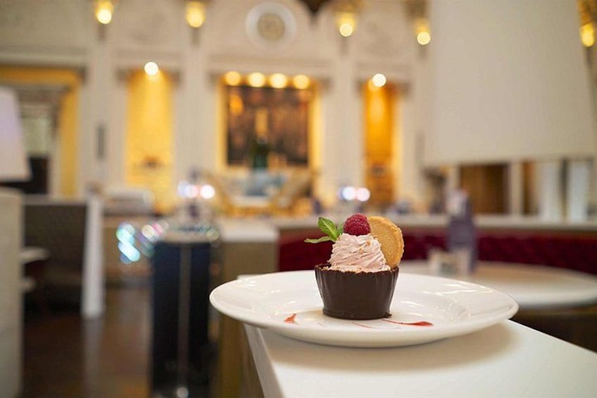 A dessert on a white plate in a restaurant with a blurred background. 3