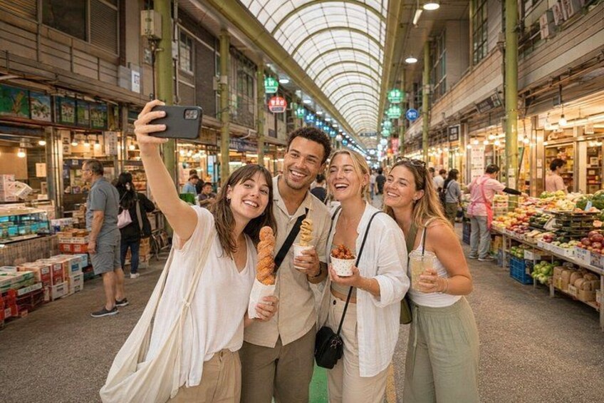 An indoor market with people shopping and taking a selfie. 1