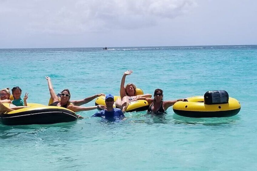 People floating on water using yellow inflatable rafts. 1