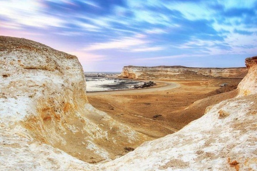 A desert landscape with prominent rock formations and a clear sky. 2