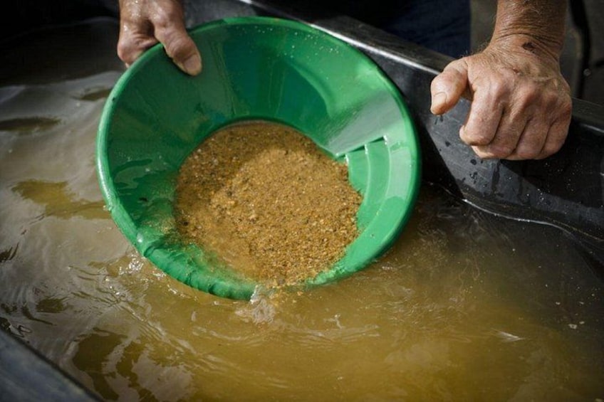 A person holding a green bowl over a liquid surface. 4