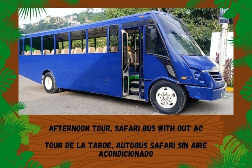 A blue safari bus parked on a road with a cityscape in the background. 2