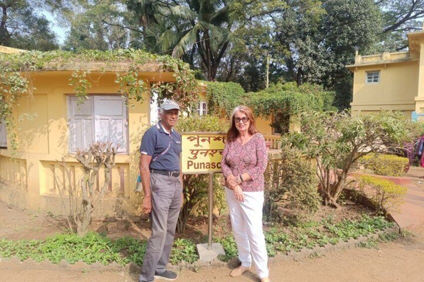 Two people standing in front of a building with a sign that reads 'Punasco.' 4