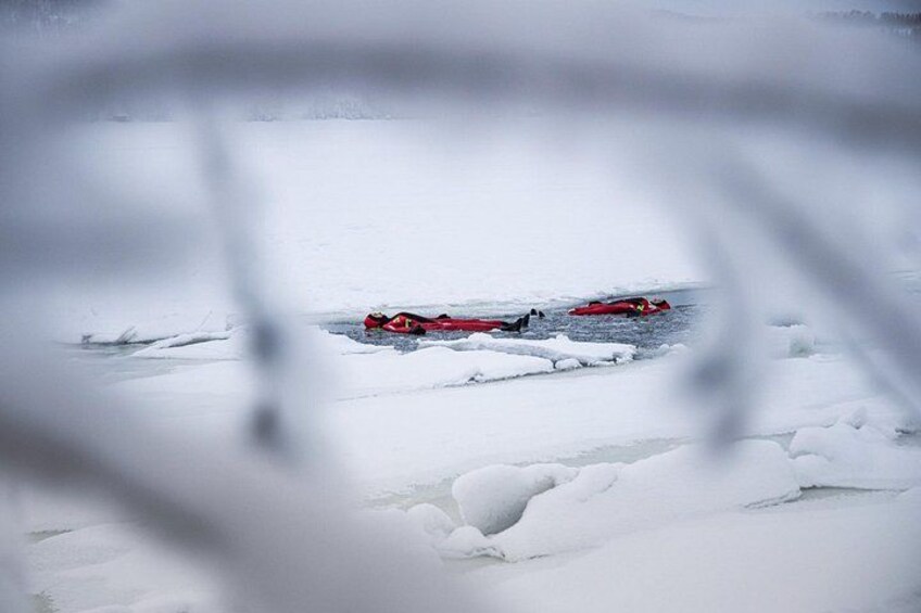 Two red kayaks on a frozen lake. 3