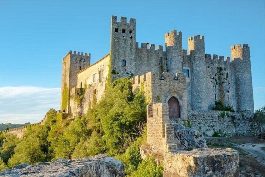 A historic castle with multiple towers and a large arched entrance. 5