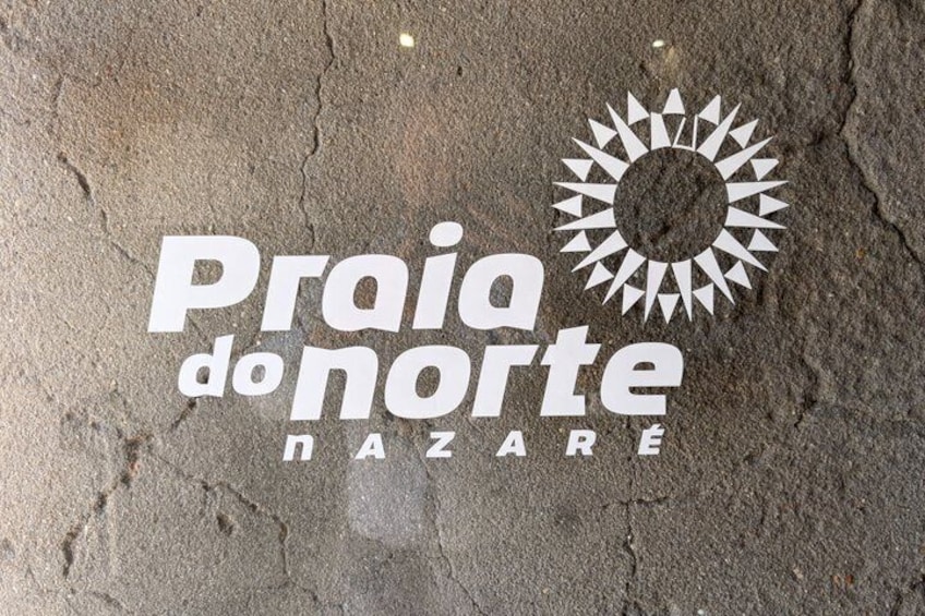 A logo with the text 'Praia do Norte' and a sun-like symbol. 3