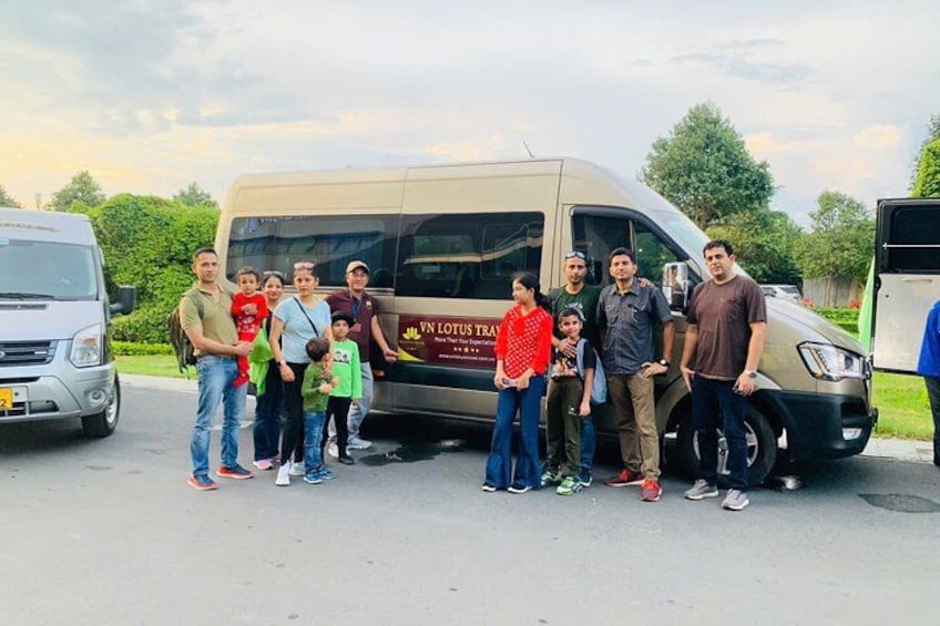 A group of people standing in front of a van with 'IN LOTUS TRAY' written on it. 2