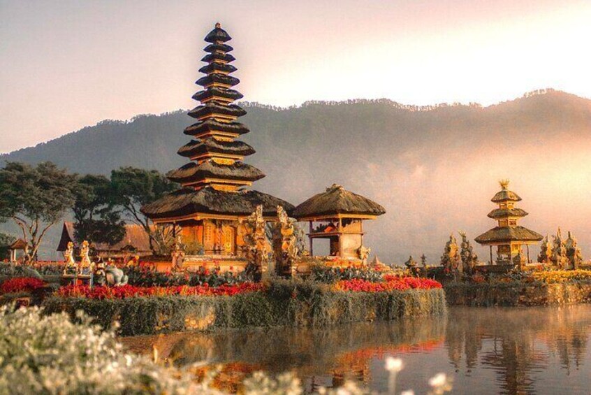 A pagoda with a tiered roof, a small pavilion, and a reflection in the water. 1