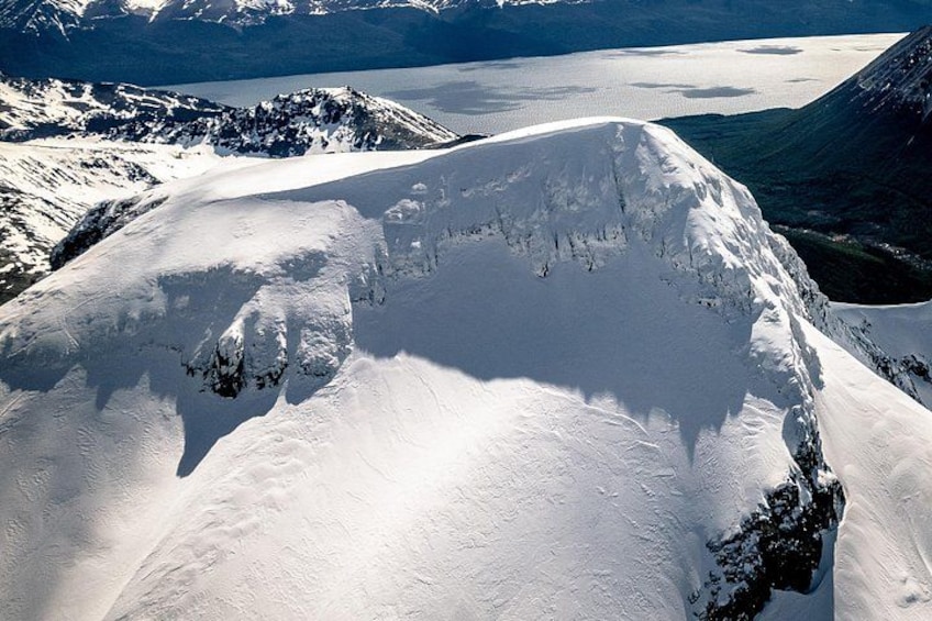 A snow-covered mountain peak with a glacier in the background. 1