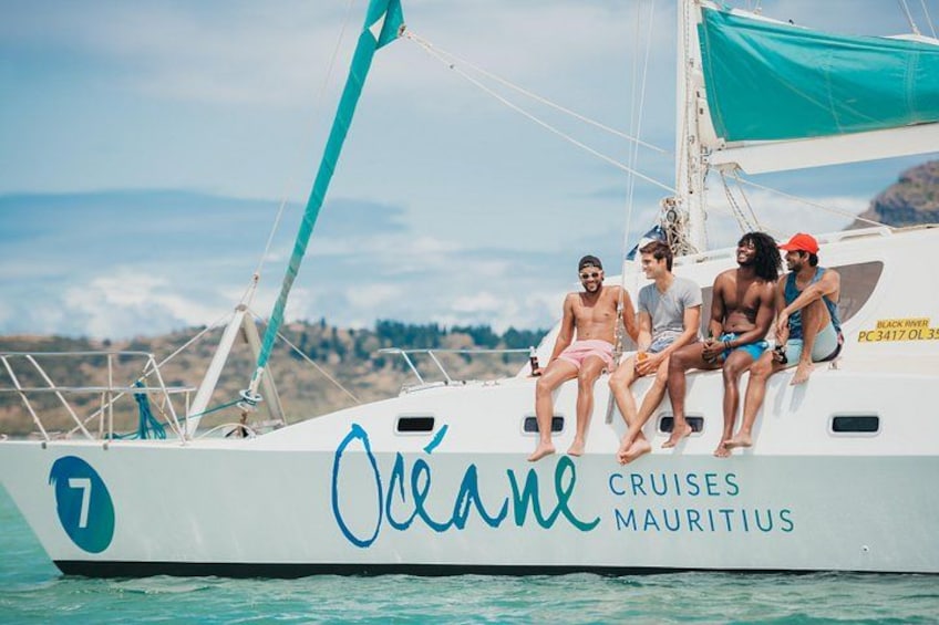 A white boat with the name 'Ocean' and 'Cruises Mauritius' written on it, with a number '7' visible. 2