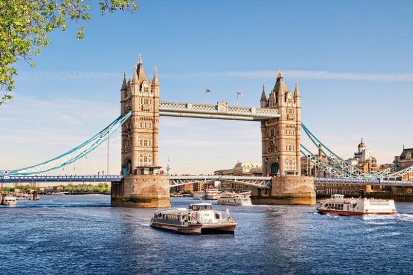 The Tower Bridge in London with boats on the river. 1