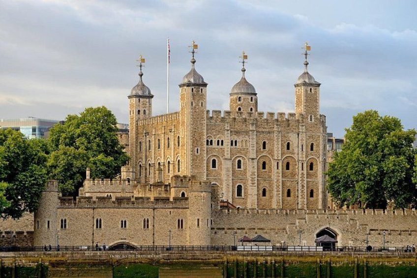 A historic stone castle with multiple towers, a moat, and a bridge. 3