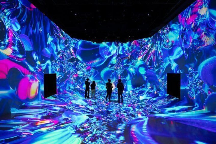 An indoor space with a large digital display featuring abstract, colorful patterns. 4