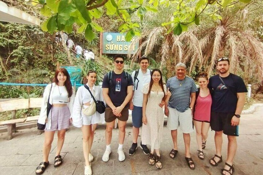 A group of people posing in front of a sign that reads 'HA SŪNG SŪNG.' 3