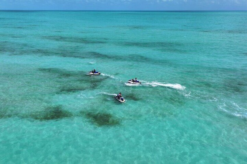 Three jet skis on turquoise water. 4