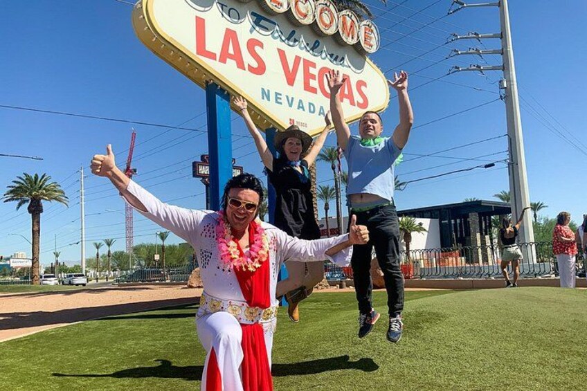 A sign with 'Las Vegas' written on it, palm trees, and a clear sky. 5