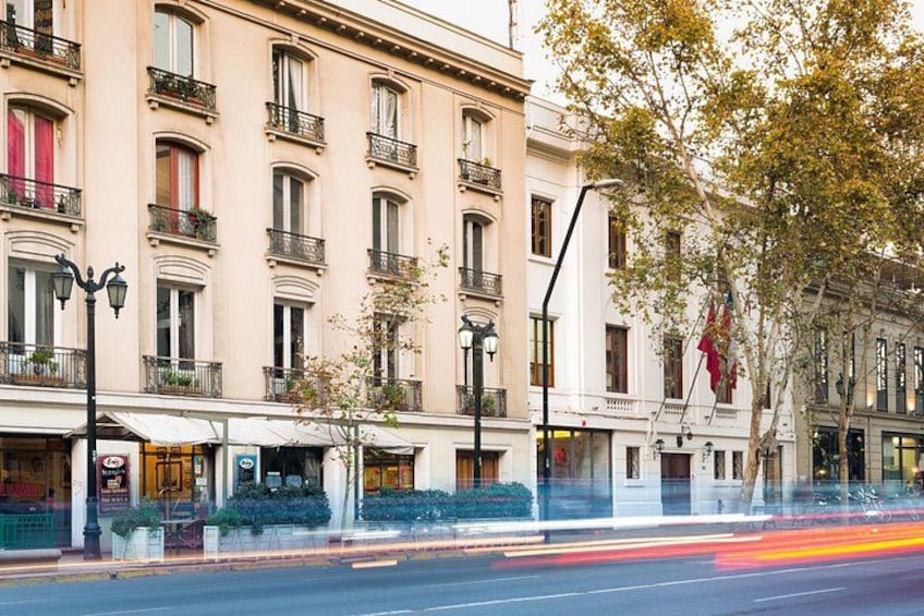 A street with buildings, a tree, and a street lamp. 4