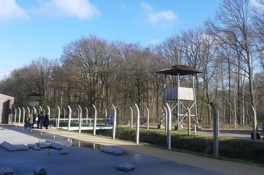 A park with a viewing platform, a wooden structure, and a row of arches. 1
