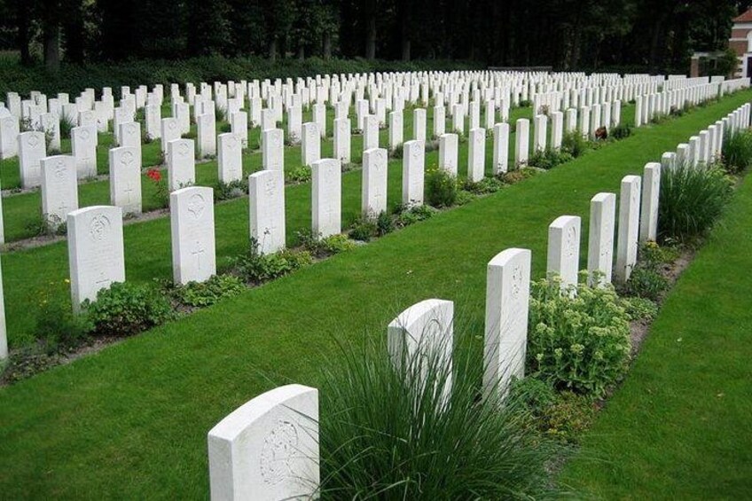A cemetery with rows of white headstones. 2