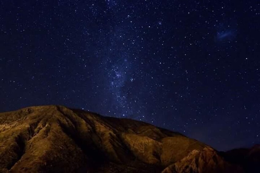 A starry night sky over a mountain. 3