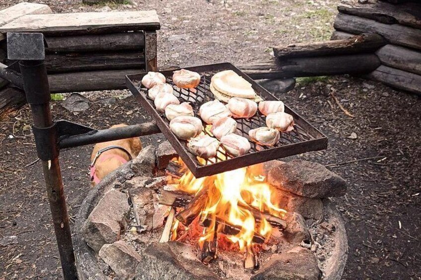 A grill with garlic cloves over an open fire. 2