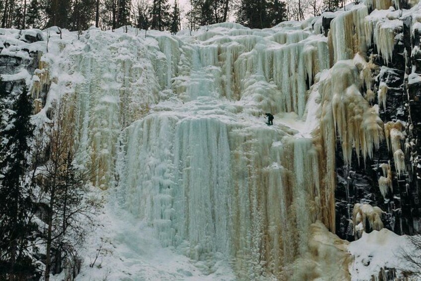 A multi-tiered frozen waterfall with icicles and snow. 1