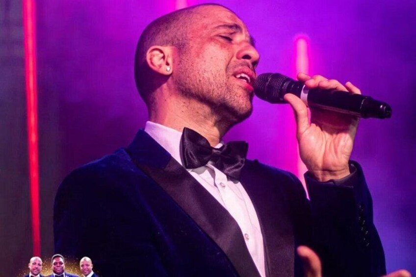 A person in a tuxedo holding a microphone. 2