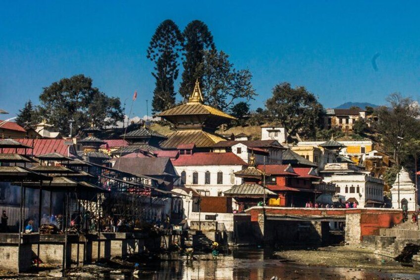 A traditional building with a golden spire, a river, and a bridge. 5