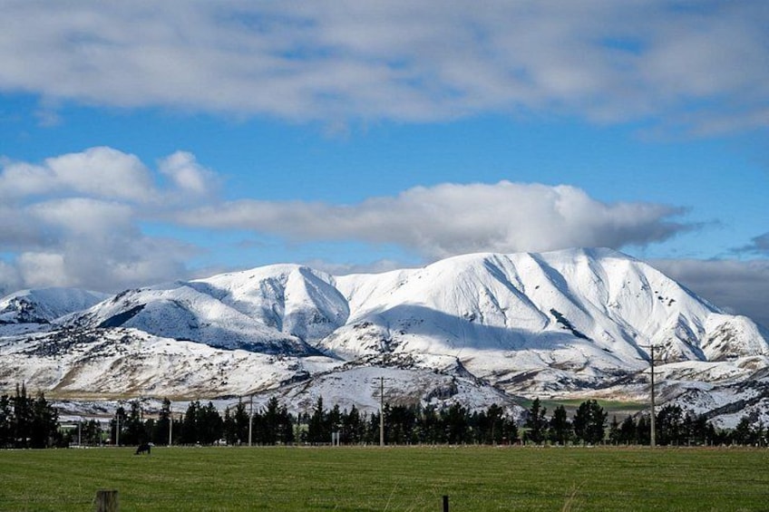 A snow-covered mountain range with a clear sky. 3