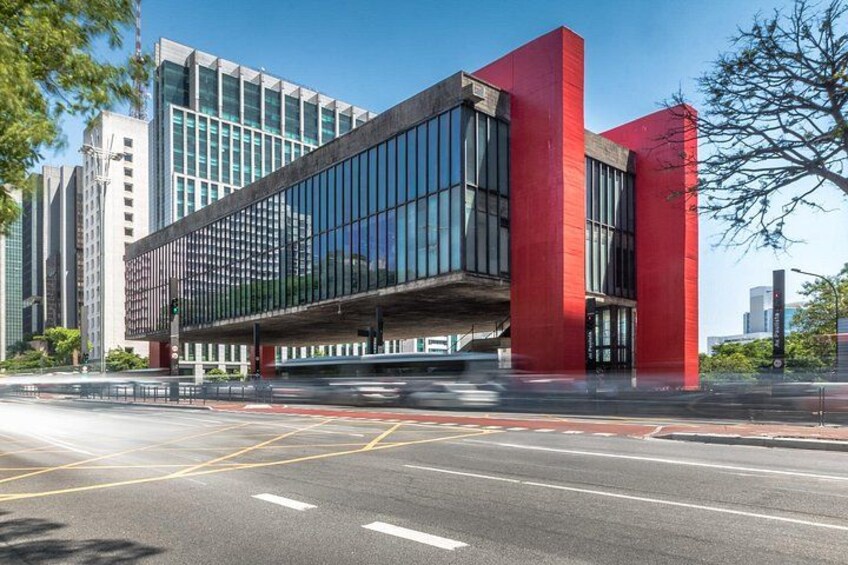 A modern building with a red facade and large windows. 3