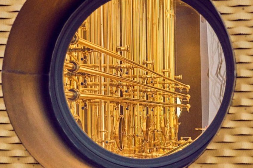 A brass musical instrument, possibly a trumpet, reflected in a circular mirror. 2